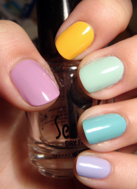 Beautiful colored pastel colors nail polish on hand, closeup. Nail art  manicure concept Stock Photo by ©HBRH 137088800